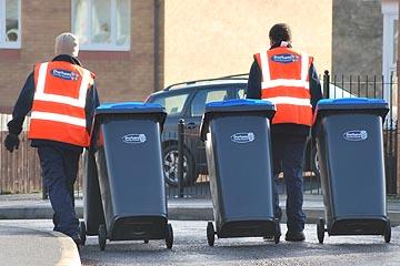 Two bin men with a wheelie bin