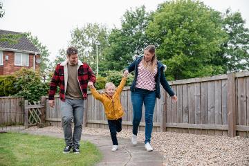 Man and woman walking with child