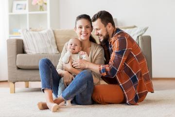 Man and woman with baby on cushion