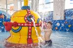 Leisure transformation boy playing with splash machine in pool