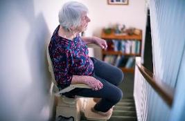 Elderly lady using a stair lift
