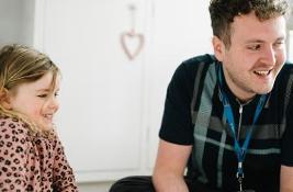 Council social worker carrying out a home visit with a young child