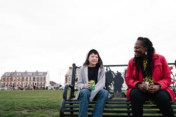 Woman and child sitting on a bench