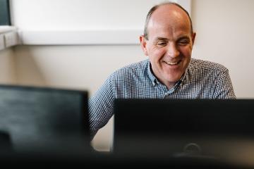 Man working in front of computer screens