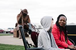 Social worker sat on bench talking to young person