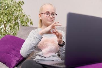 Deaf teenage girl using sign language 