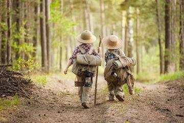 Young boys wearing backpacks while hiking