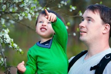 Father and his little son outdoors in spring park