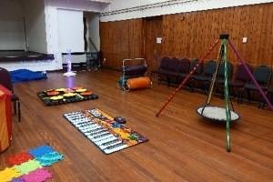 Room containing toys laid out on floor for children with special educational needs and disabilities