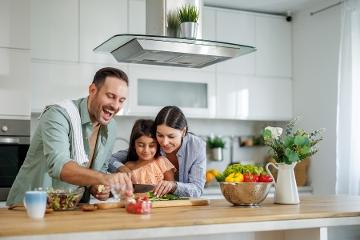 Happy family preparing healthy food together in the kitchen